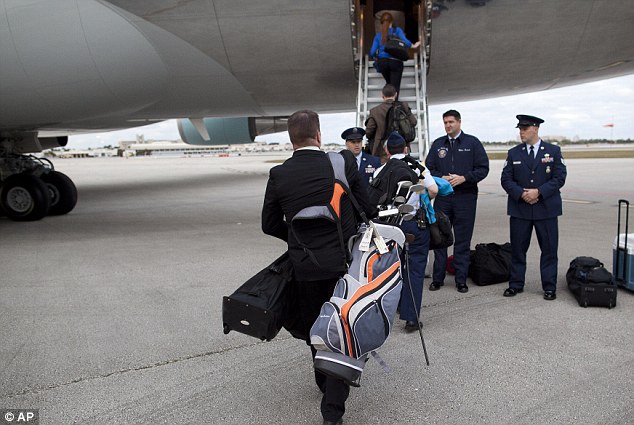 White House Aide Boarding Air Force One with Golfing Equipment