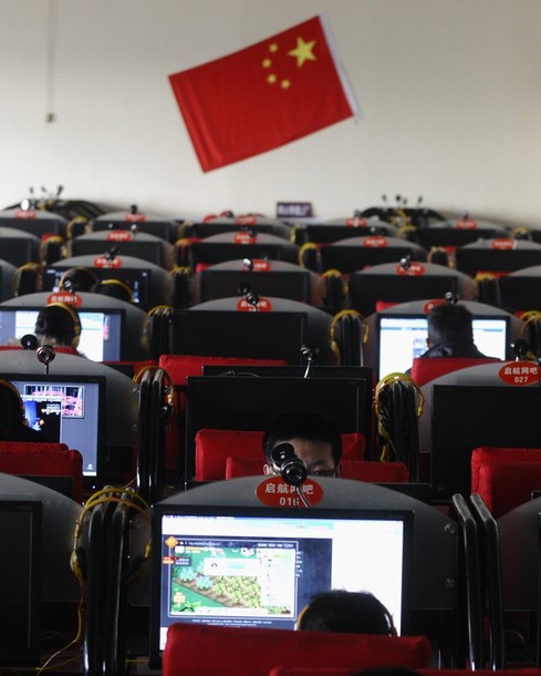 People use computers at an Internet cafe in Changzhi