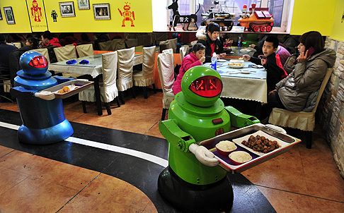 Robots deliver dishes to customers at a Robot Restaurant in Harbin